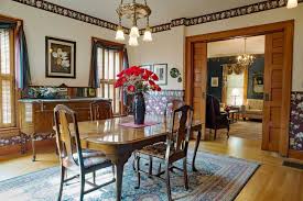 Amazing dining room features a round wood and iron dining table surrounded by restoration hardware klismos upholstered side chairs atop wood herringbone floors placed in front of glass double doors dressed in natural linen drapes. 12 Different Types Of Interior Door Styles Home Stratosphere