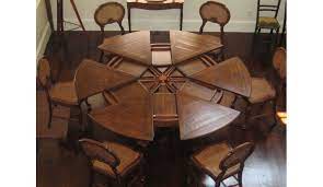 The pedestal features 6 convex members resting on a circular base. Solid Walnut Jupe Dining Table 84