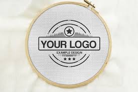 Upload your logo design to our free mockup generator and get hundreds of stunning brand identity mockups in seconds. Create An Embroidery Logo Effect Online A Simple Cross Stitch Logo Mockup Generator For Showcasing Your Ar Embroidery Logo Logo Mockup Cross Stitch Embroidery