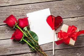 Maybe you would like to learn more about one of these? Valentines Day Greeting Card Red Rose Flowers Candy Heart And Gift Box On Wooden Table Top View With Copy Space Stock Photo Picture And Royalty Free Image Image 69949287