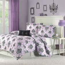 A purple bedroom with a black bed, neutral ottomans, mirror nightstands, table lamps with green bases and shiny accessories here and there. Purple And Black Damask Bedding Interiors By Color