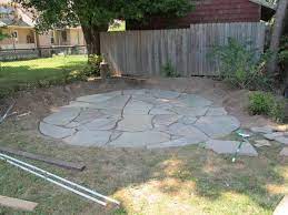 Once you have the stones in place in your diy stone patio, you need to dump several bags of sand on the top of the patio. How To Install A Flagstone Patio With Irregular Stones Diy Network Blog Made Remade Diy