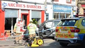 Perth • a singaporean man behind the wheel of a grey holden sports utility vehicle with his family on board died after colliding with another vehicle on a scenic coastal road north of perth. Car Crashes Into Perth Barber S Shop Bbc News