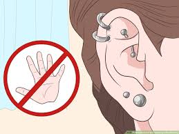 How long do ears stay swollen after ear piercing them? 3 Ways To Reduce Pain Caused By A New Piercing Wikihow