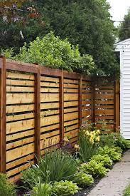 13 cheap fence ideas that still protect your yard this fence has a lattice style pattern but in wood so it s different from the plastic and composite you likely usually see. 20 Backyard And Garden Fencing Ideas Simphome Privacy Fence Decorations Diy Privacy Fence Privacy Fence Designs