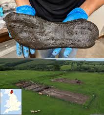 Archaeologists excavating the defensive “ankle-breaker” ditches at Magna  Fort uncovered a remarkable artifact: a 2,000-year-old giant shoe, perfectly  preserved in the oxygen-poor soil. The find immediately astonished the team.  The shoe measures
