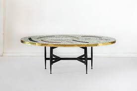 The coffee table creates a common focal point in any living room and is essential in serving and entertaining guests. Boomerang Coffee Table Rooms Studio
