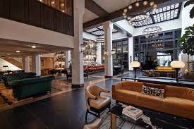 Our reception area chairs are no exception, as they have been built to last. Hotel Lobby With Sofa Chairs High Ceiling And Bar In The Background Hotel Interior Design Hotel Lobby Layout Commercial Interior Design