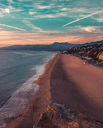 Tubesteak stands in the middle of it all holding a photo of a big wave at waimea bay, hawaii. How To Have A Perfect Weekend In Malibu Samantha Brown S Places To Love