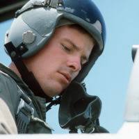 US Navy (USN) Commander (CDR) James Hineline, the"Air Boss"aboard the USN  Nimitz Class Aircraft Carrier USS RONALD REAGAN (CVN 76) adjusts his  headset in preparation of USN Carrier Air Wing 14 (CVW-14)
