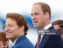 Prince William, Duke of Cambridge speaks with pilot John Romain as he...  News Photo