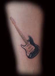 Guitar tattoos for guys can be colorful if you are into bright designs. Tiny Guitar On A Tiny Calf 2 Tall By Joe Miller Tattoonow