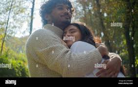 Carefree Arabian Indian affectionate couple smiling woman man male boyfriend  hugging female girlfriend wife husband enjoy closeness in park romantic  Stock Photo - Alamy