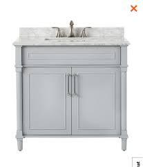 It's crafted from solid and engineered wood with a white marble countertop featuring a beveled edge and those iconic gray veins. White Vs Light Gray Bathroom Vanity