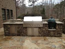 See more ideas about outdoor kitchen, big green egg table, green egg grill. An Outdoor Stone Kitchen Island With Sink Gas Grill And Big Green Egg Outdoor Kitchen Island Outdoor Kitchen Outdoor Kitchen Design