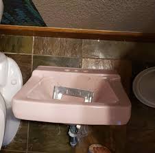 pink sink with a diy brass base