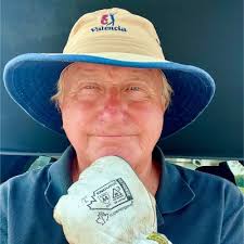 The team out performing the artificial turf maintenance.