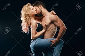 Brytal Bearded Man Kissing His Girls Neck Keeping Her Leg. Close Up  Portrait. Isolated Black Background. Studio Shot. Stock Photo, Picture And  Royalty Free Image. Image 127444773.