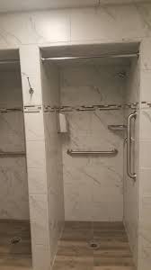Locker Room Modernization Where Each Shower Stall Has A Marmolux Corner Shelf Moen Shower Head And Control Leve Shower Panels Moen Shower Locker Room Bathroom