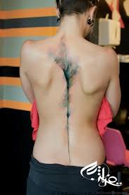 Faded Color Tattoo On Middle Back Body Tattoos Watercolor Abstract Tattoo Spine Tattoos