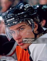 Gene Carr of the New York Rangers fights with Keith Magnuson of the... News  Photo