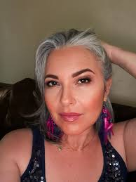 It took 18 months. I had very dark brown hair before I started. I asked the  hair stylist to help me and she did some heavy highlights to help blend the  gray