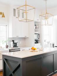 Trend We Re Loving Two Toned Kitchens Farmhouse Living Black Island With White Cabinets Iro Trendy Farmhouse Kitchen Black Kitchen Island Modern Kitchen