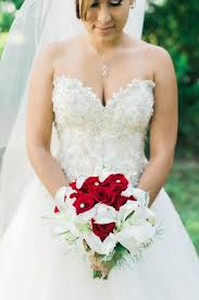 Wedding bouquet of red roses, white miniature calla lilies and white freesia. Red Rose And White Lily Bridal Bouquet