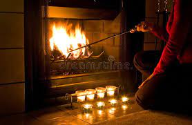 romantic fireplace woman in red sweater stoking a fire in the fireplace with ca aff red sweater woman roman fireplace candles in fireplace romantic