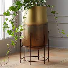Many are available in elaborately designed sets that provide platforms and spacing for multiple items so you can display all your plants in a cohesive manner. Strata Patinaed Brass Planter On Stand Reviews Cb2 Planters Brass Planter Indoor Planters
