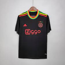 The kit is a tribute to the ajax fans and the love shared by the club and its fans for reggae legend on the back of the jersey, just below the collar, it features a subtle reference to the iconic marley song, with three little birds sitting on amsterdam's. Ajax X Bob Marley 21 22 Third Kit Futbol Shop Us