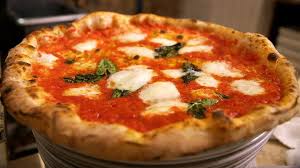 Neapolitan pizza features fresh mozzarella cheese, tomato sauce and basil on a soft and lightly charred crust. Pizzerias Seek Certification For Neapolitan Pizza But Some Say It S Cheesy Wsj