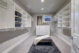 Revamping your closet can help so why not create some seating within the closet? Huge Walk In Closet With Shelves Drawers And Gray Bench Northwest Stock Photo Picture And Royalty Free Image Image 70256645