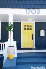 When paired with a red door like this, a dark blue house with white trim can look even more classical. Blue Door Yellow House Door Inspiration For Your Home