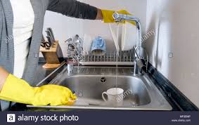 young housewife washing dishes