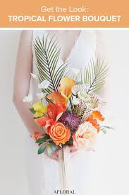 The flowers here is a coral red shade while we have some other coral orange fake flowers. Get The Look Tropical Flower Bouquet Coral Wedding Flowers Wedding Bridal Bouquets Wedding Bouquets Bride