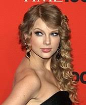 Taylor poses for a photoshoot on a beach. Taylor Swift Wikipedia