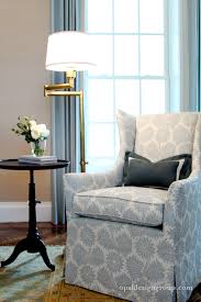 Floor lamps can be adjustable with arcs that can be directed over a comfy sofa or positioned vertically for discreet corner lighting. Antique Brass Swing Arm Floor Lamp Transitional Living Room Opal Design Group