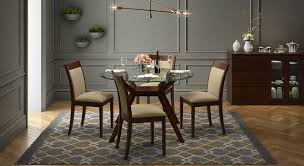 A simple and sturdy set that's perfect for your breakfast nook or smaller dining area. Wesley Dalla 4 Seater Round Glass Top Dining Table Set Urban Ladder
