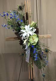 River Cane Cross Blue Delphinium White Oriental Lilies Greenish White Kale Robellini Peacock Feathers Funeral Floral Funeral Flowers Flower Arrangements