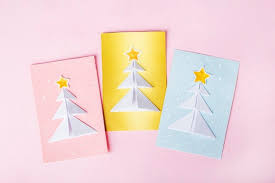 You can turn the paper design into a hanging christmas ornament too. Premium Photo Concept Of Diy And Kid S Creativity Origami Make Blue Pink Golden Greeting Cards With Christmas Trees Origami
