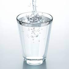 Woman in white tank top on water during daytime. A Glass Of Water Can Go Off Over Night And Here S Why