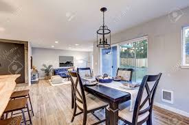 Choose from a variety of sizes and shapes of unfinished pedestal columns, unfinished dining table legs, table feet, table extension slides and more. Open Plan Dining Room Interior With Light Wood Floors Showcases A Black Dining Table Set Sliding Doors To Backyard And Floor To Ceiling Framed Chalkboard Northwest Usa Stock Photo Picture And