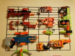 Space out 2 pegs at approximately the same length as hang a wire rack on your wall using screws, anchors, or other attachments depending on the wall material. Nerf Gun Airsoft Wall Display 4 Steps With Pictures Instructables