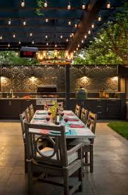 A table with a flat surface for prep, a tiered bar cart or shelf for storage, a grill, and a cooler. 69 Outdoor Kitchen Bar Ideas Sebring Design Build