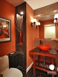 The room has a large cozy bed and has glass windows. Cheerful Spunk Enliven Your Powder Room With A Splash Of Orange