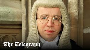 Judge mugged at champagne bottle-point by thief who demanded kiss goodbye,  court hears