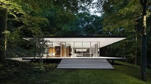 The common trends we usually see in new developments include open concepts, harmony with nature, huge glass windows putting interiors on there's a lot to love these residences for, both small and large. A Glass House Framed By A Lush Forest And A Beautiful Lake