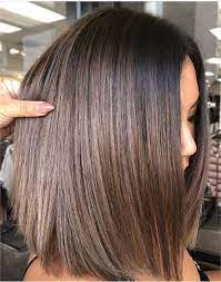 A charming brunette looks in front of her, then to the sides and down frowning her forehead and shrugging shoulders. 45 Brunette Looks We Re Falling For This Season Hair Color Modern Salon Blondehairstyles Haarfarben Haarfarben Ideen Schone Haare