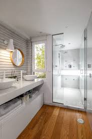 The concrete flooring and exposed wooden ceiling provide amazing textures to this simplistic bathroom. Modern Beautiful Bathroom With Natural Light By Victor Torres Stocksy United